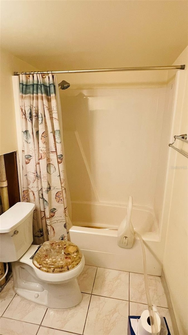 bathroom with tile patterned flooring, shower / tub combo, and toilet