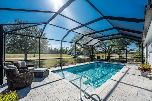 view of pool featuring a lanai, a patio area, and a lawn