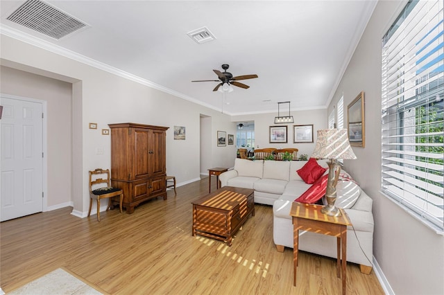 living room featuring crown molding, ceiling fan, and light wood-type flooring