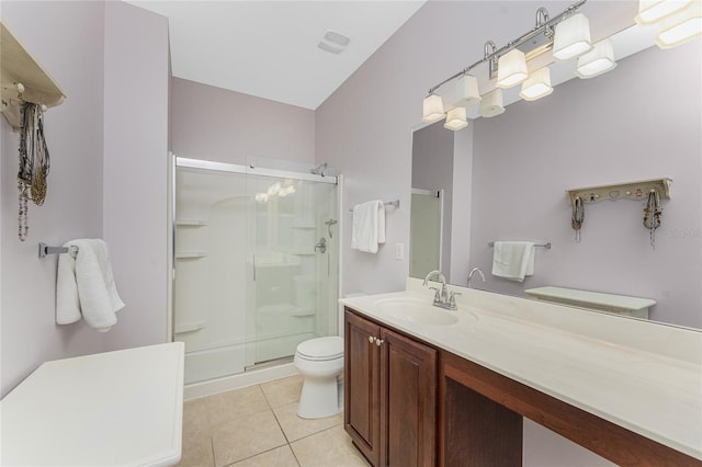 bathroom featuring tile patterned flooring, toilet, an enclosed shower, and vanity