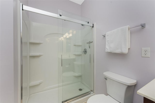 bathroom with a shower with door and toilet