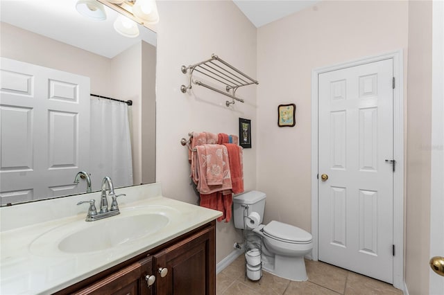 bathroom featuring tile patterned flooring, vanity, and toilet