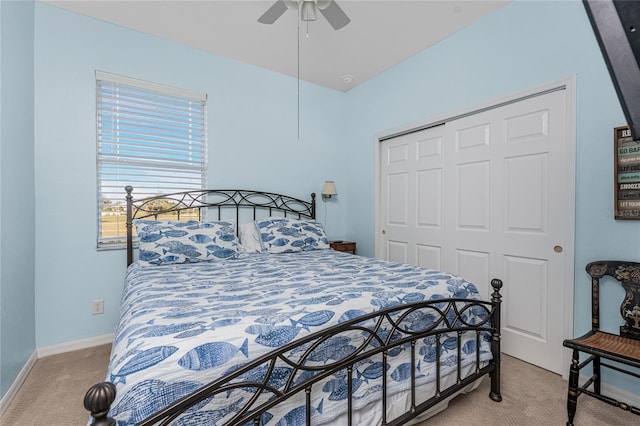 carpeted bedroom featuring a closet and ceiling fan