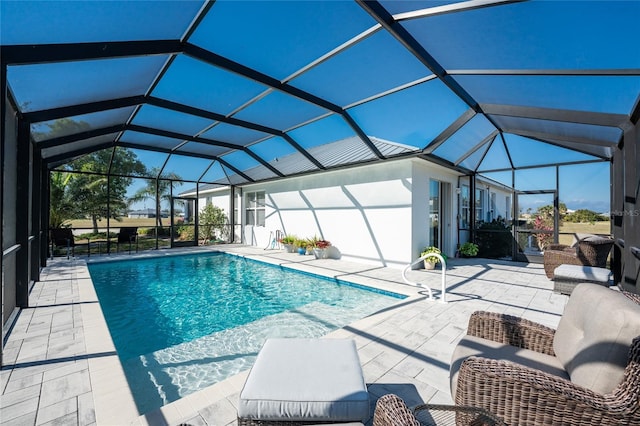 view of pool with a patio area and a lanai