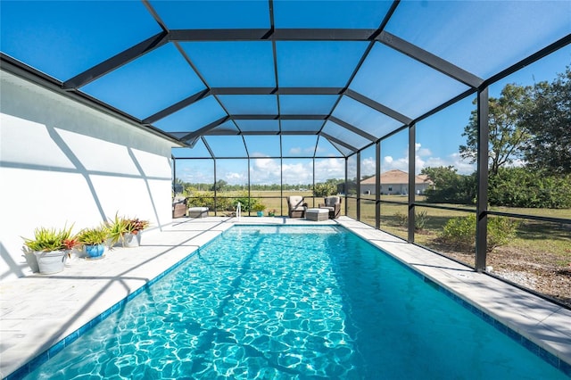 view of swimming pool featuring glass enclosure, a patio area, and outdoor lounge area