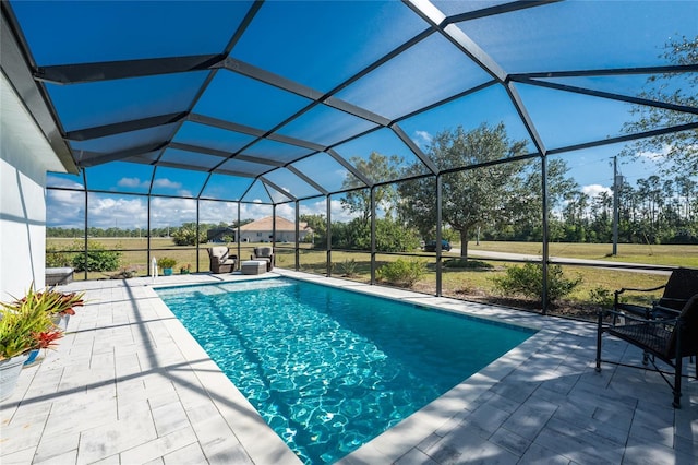 view of pool with a lanai and a patio