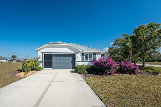 view of front of property with a front yard and a garage