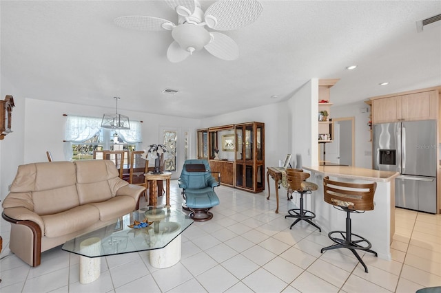 tiled living room with ceiling fan