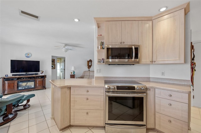 kitchen featuring appliances with stainless steel finishes, light brown cabinetry, kitchen peninsula, and light tile patterned floors