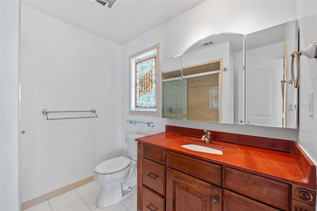 bathroom featuring toilet, tile patterned flooring, a shower with shower door, and vanity