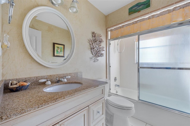 full bathroom featuring toilet, enclosed tub / shower combo, and vanity