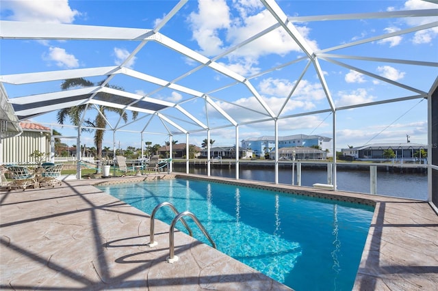 view of pool featuring a patio, a water view, and glass enclosure