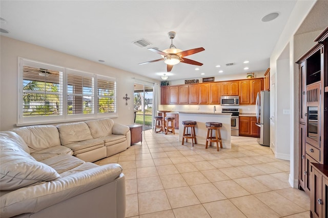 living room with ceiling fan and light tile patterned floors