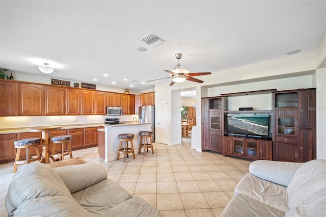 living room with ceiling fan and light tile patterned flooring