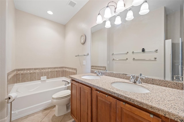 bathroom with tile patterned floors, vanity, toilet, and a bath