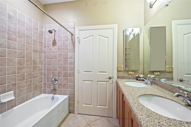 bathroom featuring tile patterned floors, vanity, and tiled shower / bath