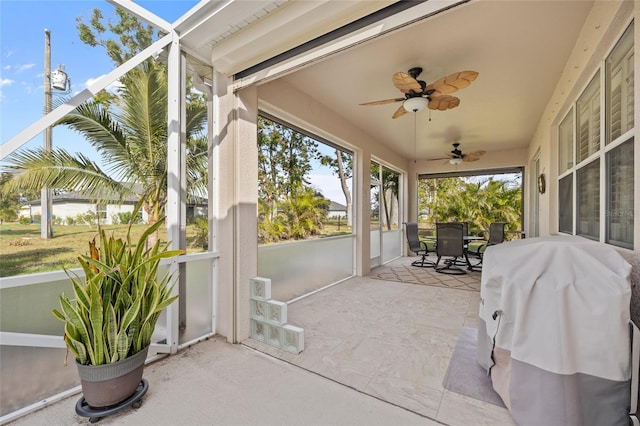 sunroom / solarium featuring ceiling fan