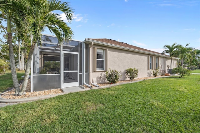 back of house featuring a lanai and a lawn