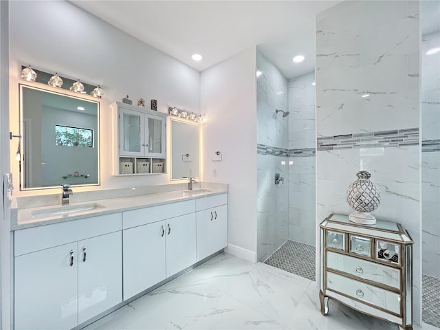 bathroom with vanity and a tile shower