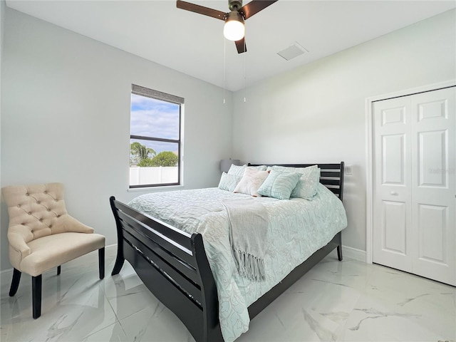 bedroom with ceiling fan and a closet