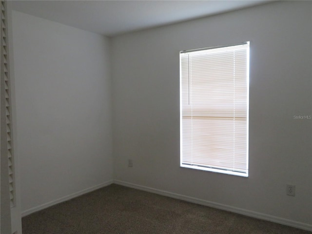 empty room featuring dark colored carpet