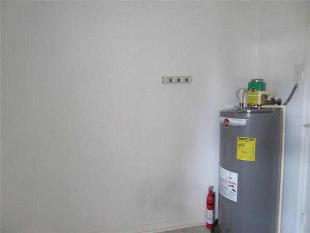 utility room featuring electric water heater