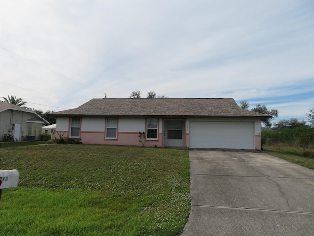 ranch-style home with a garage and a front lawn