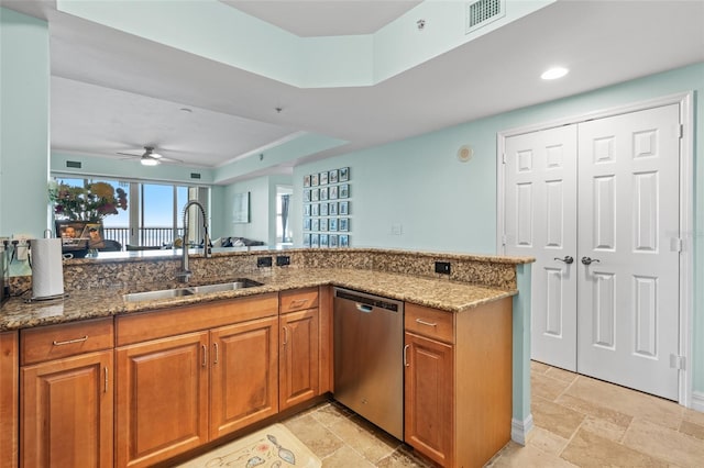 kitchen with dishwasher, stone countertops, ceiling fan, and sink