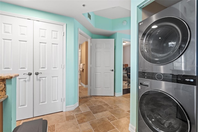 clothes washing area with stacked washer / drying machine