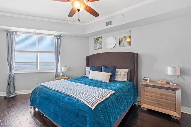 bedroom with dark hardwood / wood-style floors, ceiling fan, ornamental molding, and a water view