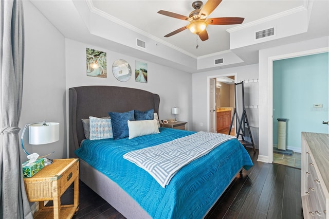 bedroom with a raised ceiling, ensuite bath, ceiling fan, and dark hardwood / wood-style flooring