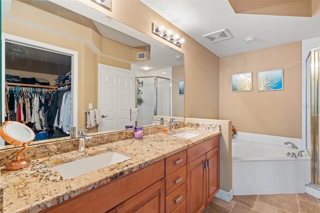 bathroom with vanity and independent shower and bath