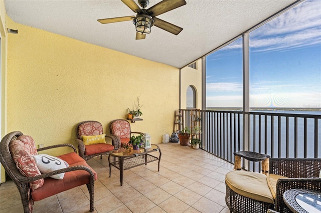 sunroom featuring ceiling fan