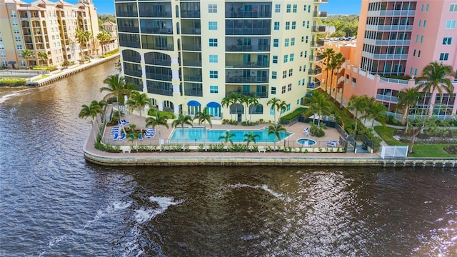 view of property with a water view and a community pool