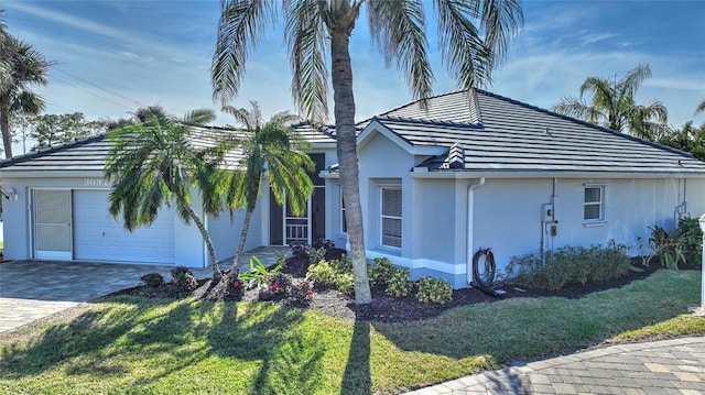 view of front of home with a front yard and a garage