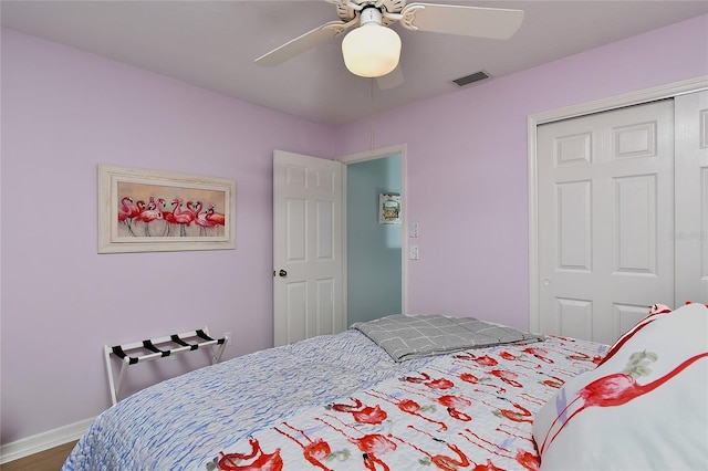 bedroom with ceiling fan and a closet