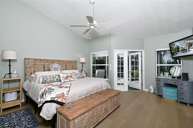 bedroom with hardwood / wood-style floors, access to outside, vaulted ceiling, and ceiling fan