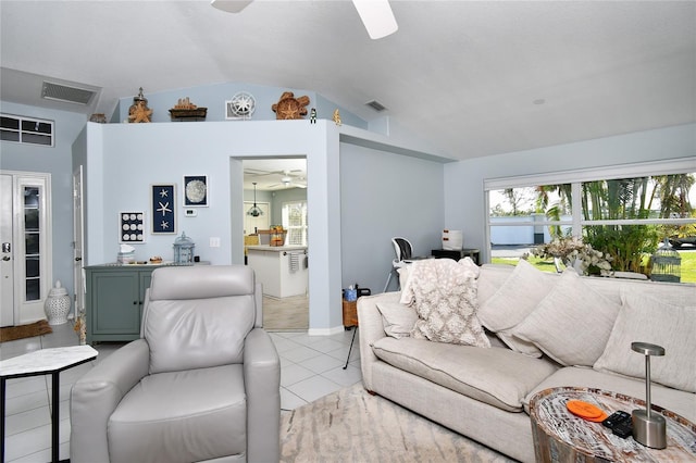 living room featuring ceiling fan, lofted ceiling, and light tile patterned flooring