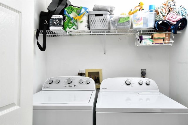 clothes washing area with washer and dryer