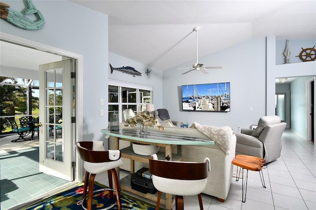 dining room featuring ceiling fan, light tile patterned flooring, and lofted ceiling