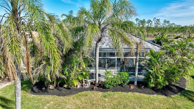 rear view of house featuring a lanai and a swimming pool