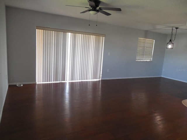 unfurnished room featuring dark hardwood / wood-style flooring and ceiling fan