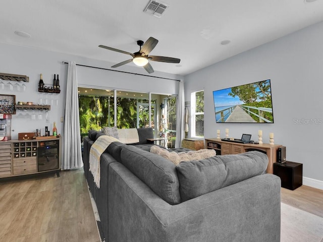 living room featuring ceiling fan and light hardwood / wood-style floors