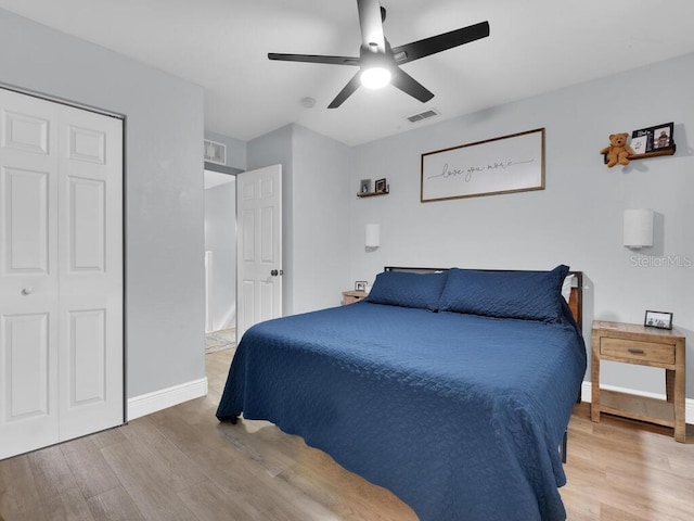 bedroom with ceiling fan, a closet, and wood-type flooring