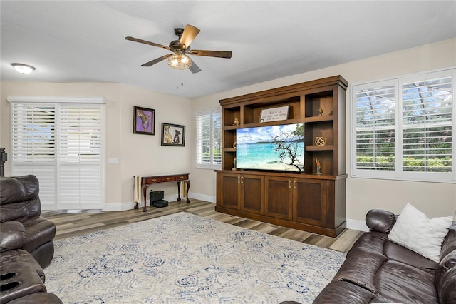 living room featuring ceiling fan and light hardwood / wood-style floors