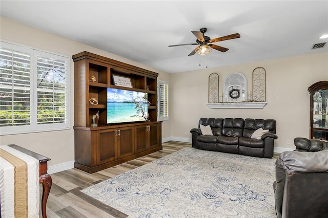 living room with ceiling fan and light hardwood / wood-style flooring