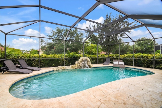 view of pool with a lanai, pool water feature, and a patio