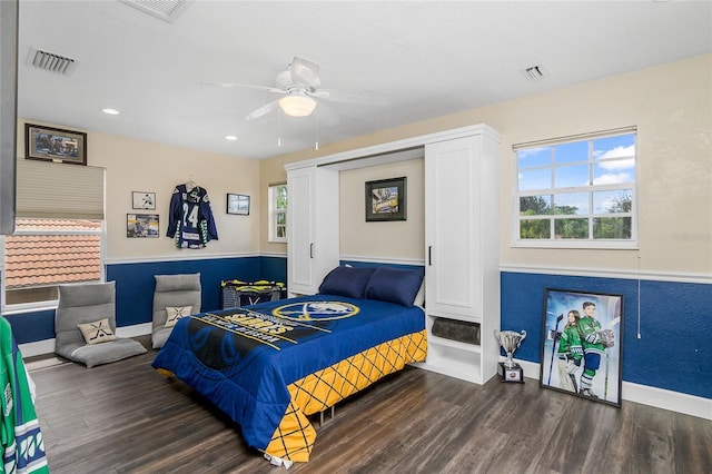 bedroom with ceiling fan and dark hardwood / wood-style flooring