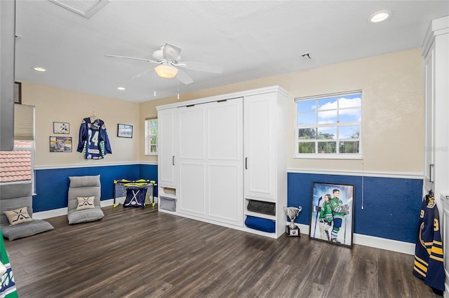 sitting room with dark hardwood / wood-style flooring and ceiling fan