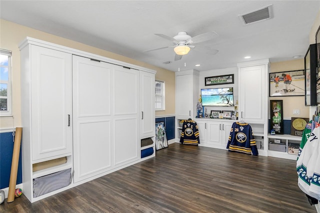 interior space with ceiling fan and dark wood-type flooring